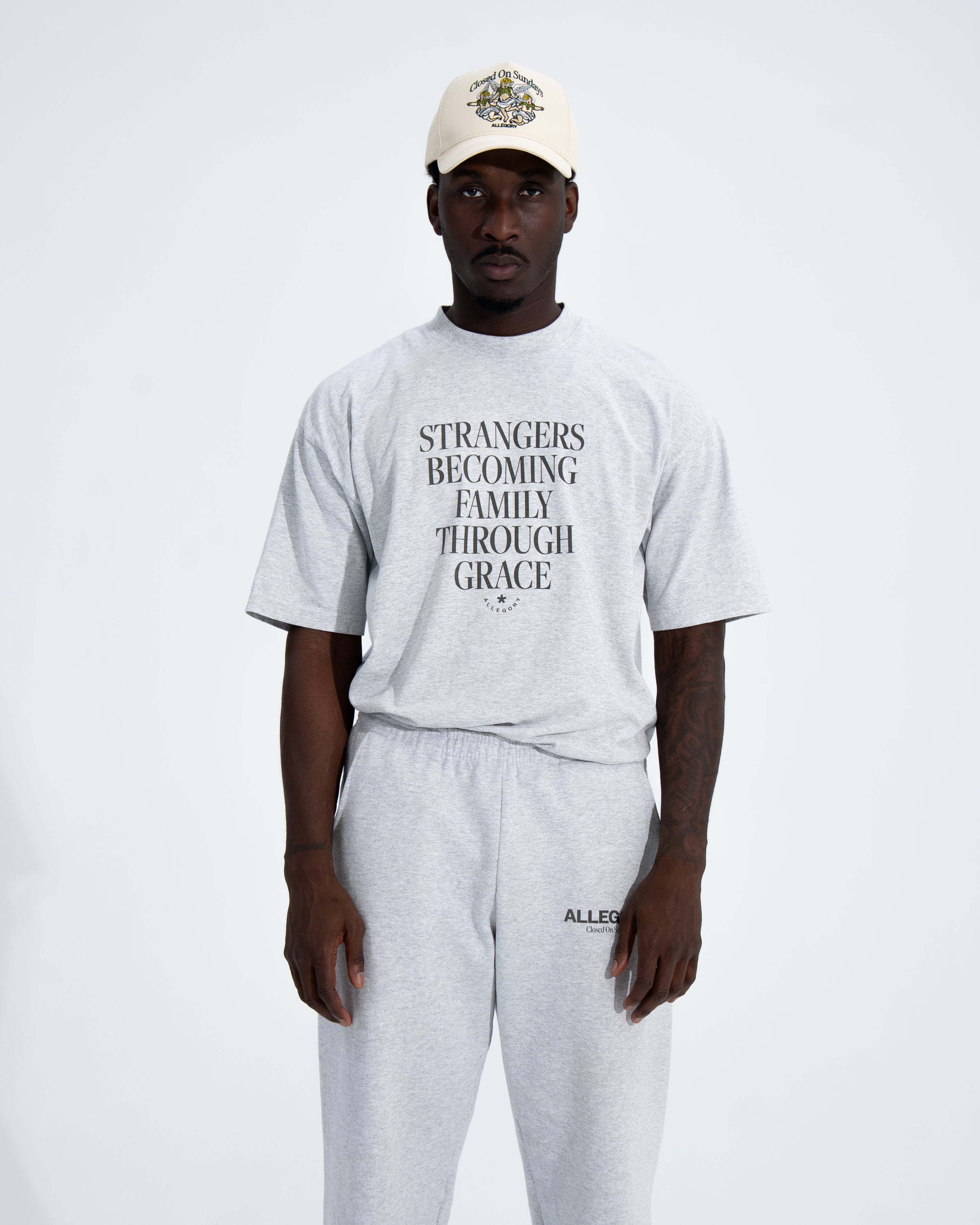 Strangers Becoming Family Through Grace Tee-3